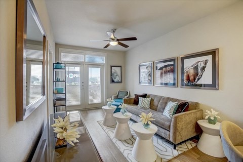 a living room with a couch and a ceiling fan